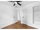 This bedroom features hardwood floors, a ceiling fan, and a closet/storage area at 6660 Hidden Brook Trl, Atlanta, GA 30349