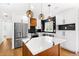 Modern kitchen with white cabinetry, stainless steel appliances, quartz countertops, and stylish pendant lighting at 6660 Hidden Brook Trl, Atlanta, GA 30349
