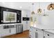 Open concept kitchen with stainless steel appliances, a quartz countertop island, and modern pendant lighting at 6660 Hidden Brook Trl, Atlanta, GA 30349