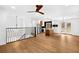Open-concept living area with hardwood floors, modern lighting, and a view of the updated kitchen at 6660 Hidden Brook Trl, Atlanta, GA 30349