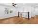 Hallway with hardwood floors, white walls, and modern railing at 6660 Hidden Brook Trl, Atlanta, GA 30349