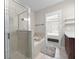 Bright bathroom boasts a separate shower and soaking tub, vanity with dark wood cabinets, and ceramic tile flooring at 2113 Gorman Se Grv, Atlanta, GA 30316