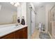 Neutral bathroom features a walk-in shower, vanity with white countertops, and a sliding barn door for privacy at 2113 Gorman Se Grv, Atlanta, GA 30316