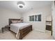 Bedroom features a bed, modern ceiling fan, a mirror on the wall and a window that brings in natural light at 2113 Gorman Se Grv, Atlanta, GA 30316