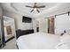 Spacious bedroom with en suite bathroom features a ceiling fan, large mirror, and a TV for your entertainment at 2113 Gorman Se Grv, Atlanta, GA 30316
