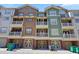 Exterior elevation featuring multi-colored townhomes with balconies and garage parking at 2113 Gorman Se Grv, Atlanta, GA 30316