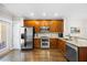 Modern kitchen featuring stainless steel appliances, wooden cabinets, and granite countertops at 2113 Gorman Se Grv, Atlanta, GA 30316