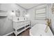Bright bathroom featuring double vanity, bathtub, brass fixtures, and modern finishes at 215 Collum Nw St, Atlanta, GA 30314