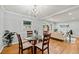 A round glass table with seating for four sits in a naturally lit space with hardwood floors at 215 Collum Nw St, Atlanta, GA 30314