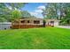 Spacious yard featuring the home's exterior with a wooden deck and well manicured lawn at 215 Collum Nw St, Atlanta, GA 30314