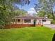 Charming home featuring an expansive wooden deck, complemented by lush green lawn at 215 Collum Nw St, Atlanta, GA 30314