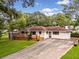 Charming ranch-style home featuring a wooden deck, white brick exterior, and well-manicured front lawn at 215 Collum Nw St, Atlanta, GA 30314