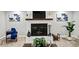 Cozy fireplace with a white brick surround, mantle, decor, and wood storage at 215 Collum Nw St, Atlanta, GA 30314