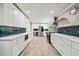Spacious kitchen featuring custom white cabinets, stainless steel appliances, and stylish backsplash at 215 Collum Nw St, Atlanta, GA 30314