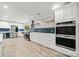 Modern kitchen boasts stainless appliances, white cabinets and sleek blue tile at 215 Collum Nw St, Atlanta, GA 30314