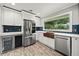Open kitchen with stainless steel fridge, copper sink, and white cabinets at 215 Collum Nw St, Atlanta, GA 30314