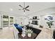Open-concept living room with fireplace, fan and seamless access to a spacious outdoor wooden deck at 215 Collum Nw St, Atlanta, GA 30314
