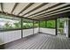 Cozy covered porch with string lights and wood flooring overlooks lush greenery at 215 Collum Nw St, Atlanta, GA 30314