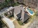 An aerial view showcases a sprawling home with a well-manicured yard, a private pool, and a circular driveway at 2160 Bradley Trl, Cumming, GA 30041