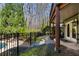 Beautiful backyard with a lush garden, wrought iron fence, and access to a refreshing pool at 2160 Bradley Trl, Cumming, GA 30041