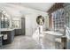 Light-filled bathroom with soaking tub, marble floors, and a unique window at 2160 Bradley Trl, Cumming, GA 30041