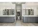 Bright, dual-sink vanity with marble floors, large mirrors, storage, and doorway to stand alone tub at 2160 Bradley Trl, Cumming, GA 30041