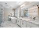 Modern bathroom with chandelier, soaking tub, large glass shower, and marble tile at 2160 Bradley Trl, Cumming, GA 30041