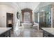 Luxurious bathroom featuring a soaking tub, glass-enclosed shower, and marble countertops at 2160 Bradley Trl, Cumming, GA 30041
