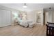 Comfortable bedroom with hardwood floors, a ceiling fan, and ensuite bathroom at 2160 Bradley Trl, Cumming, GA 30041