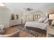 Spacious bedroom with neutral walls, hardwood floors, and two sitting chairs at 2160 Bradley Trl, Cumming, GA 30041