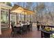 Relaxing deck with an umbrella-covered dining table for outdoor dining at 2160 Bradley Trl, Cumming, GA 30041