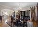 Formal dining room featuring a round table, chandelier, and views of the staircase at 2160 Bradley Trl, Cumming, GA 30041