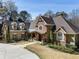 Charming stone and siding home with inviting front porch and well-maintained landscaping at 2160 Bradley Trl, Cumming, GA 30041