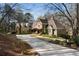 Sprawling home featuring stone and siding, mature trees and landscaping, with a long driveway at 2160 Bradley Trl, Cumming, GA 30041