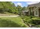 Well-manicured lawn and landscaping enhance this home's curb appeal and stone facade at 2160 Bradley Trl, Cumming, GA 30041