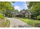 Charming home featuring a stone and siding exterior with a long driveway and mature trees at 2160 Bradley Trl, Cumming, GA 30041