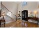 Elegant foyer featuring a soaring ceiling, decorative iron staircase, and beautiful entry doors at 2160 Bradley Trl, Cumming, GA 30041