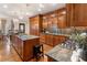 Spacious kitchen with wood cabinets, an island with barstool seating, and stone countertops at 2160 Bradley Trl, Cumming, GA 30041