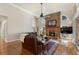 Spacious living room with hardwood floors, a stone fireplace, and a large leather sofa at 2160 Bradley Trl, Cumming, GA 30041