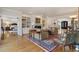 Open-concept living room with built-in shelving, hardwood floors, and views into the main bedroom at 2160 Bradley Trl, Cumming, GA 30041