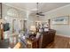 Bright living room with hardwood floors, leather sofa, and arched transom windows at 2160 Bradley Trl, Cumming, GA 30041