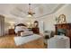Tranquil main bedroom with tray ceiling, fireplace, and hardwood floors at 2160 Bradley Trl, Cumming, GA 30041
