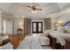 Spacious main bedroom featuring hardwood floors, tray ceiling, and French doors to a private deck at 2160 Bradley Trl, Cumming, GA 30041