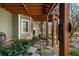 Inviting covered patio area with stone pathway, decorative columns and a peek of stylish outdoor seating at 2160 Bradley Trl, Cumming, GA 30041