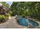 Expansive backyard with a large in-ground pool, slide and lush greenery, perfect for outdoor fun at 2160 Bradley Trl, Cumming, GA 30041