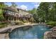 Backyard pool area with a waterfall feature, multiple lounge chairs, and a multi-tiered deck at 2160 Bradley Trl, Cumming, GA 30041
