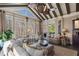 Relaxing sunroom with vaulted ceilings, beamed construction, and large windows viewing the woods at 2160 Bradley Trl, Cumming, GA 30041