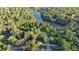 Stunning aerial view of a home nestled among lush greenery and a serene lake, offering privacy and natural beauty at 3253 Brookshire Way, Duluth, GA 30096