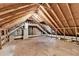 The unfinished attic offers potential for storage, ample space, and exposed beams at 3253 Brookshire Way, Duluth, GA 30096