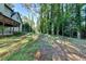 The backyard features an incline that leads up to ivy-covered trees at 3253 Brookshire Way, Duluth, GA 30096